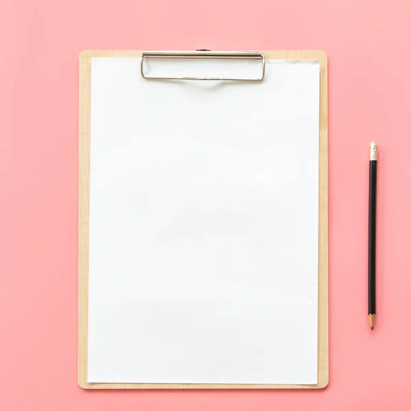 Blank clipboard and pencil mock up on pink pastel color backgrou