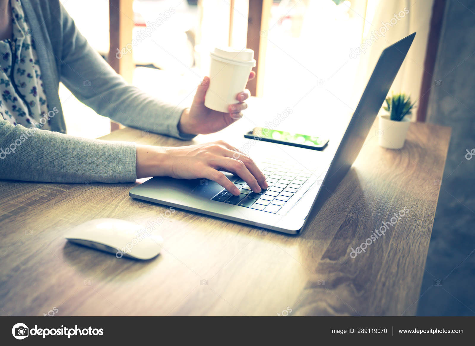 Asian woman using laptop computer do online activity on wood tab