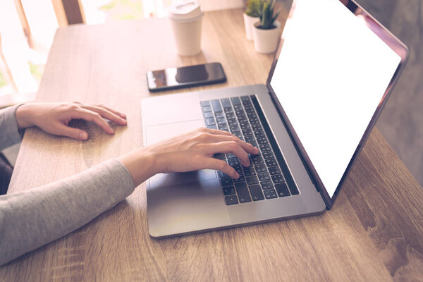 Business woman using laptop computer do online activity on wood 