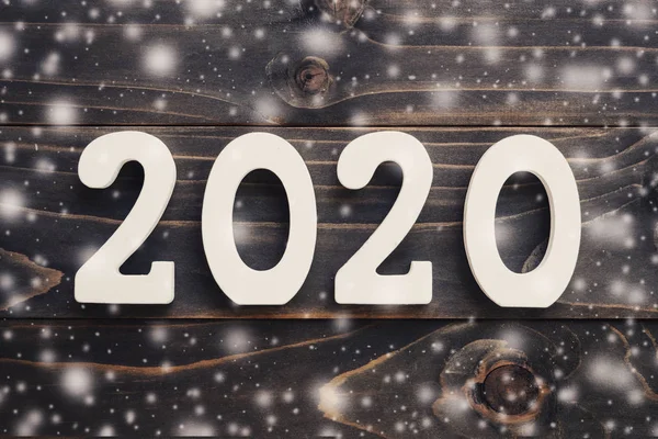 2020 New year concept : 2020 wood number with snow on table back — Stock Photo, Image