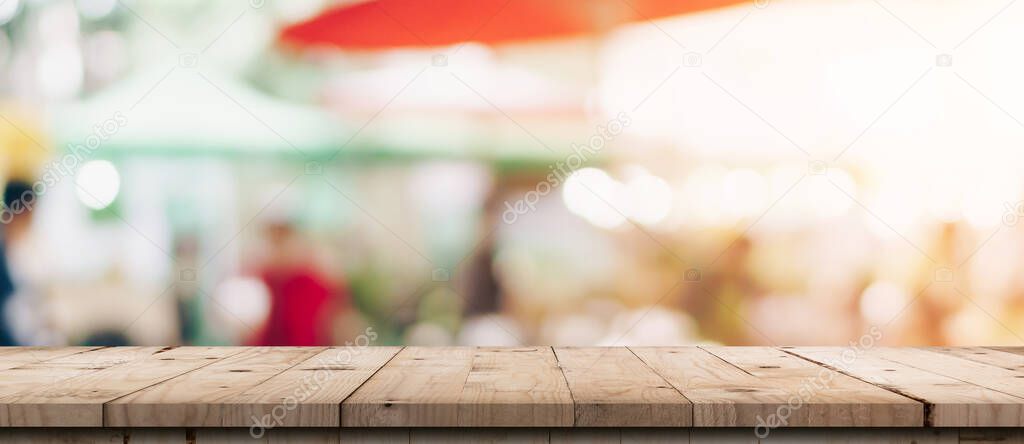 Empty wood table and blurred light table in shopping mall with bokeh background. product display template.