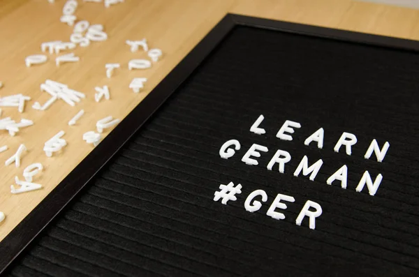 learn German language sign on black background