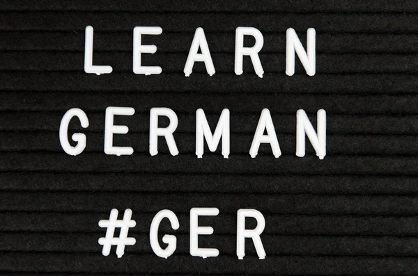 learn German language sign on black background