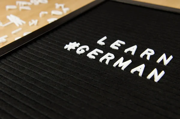 learn German language sign on black background