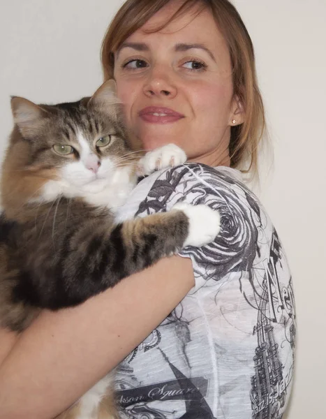 Bir kedi tutan olgun kadın