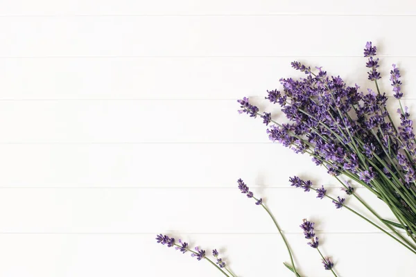 Bouquet di fiori di lavanda su sfondo bianco tavolo di legno. Cornice floreale decorativa, banner web con Lavandula officinalis. Design estivo francese, concetto di aromaterapia. Erbe profumate sane . — Foto Stock