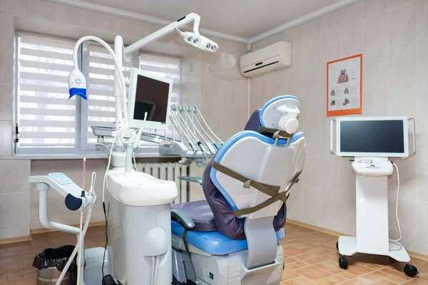 Dentist office. Modern dental cabinet. Dental instruments and tools in modern clinic, professional dentistry chair waiting to be used by orthodontist