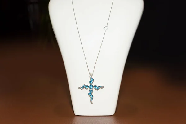 Luxury pendant with blue precious stones on plastic white stand — Stock Photo, Image