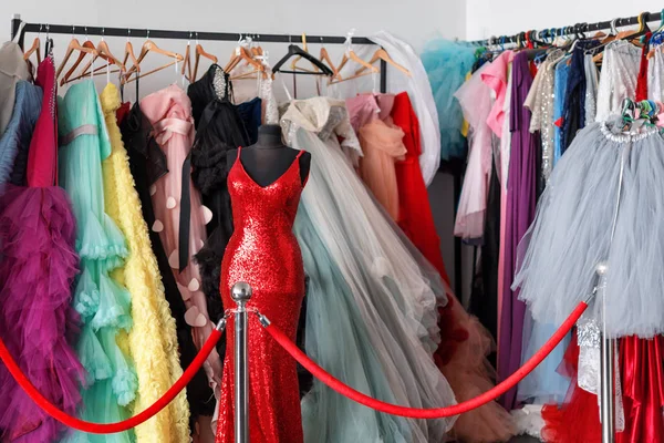 许多女士晚礼服长礼服在衣架在礼服出租商店为婚礼天或相片会议。礼服租赁概念。选择性对焦。球袍出租概念. — 图库照片