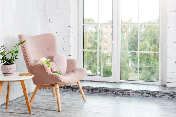 Stylish pink armchair with heart shaped pillow in a bright minimalist interior — Stock Photo, Image