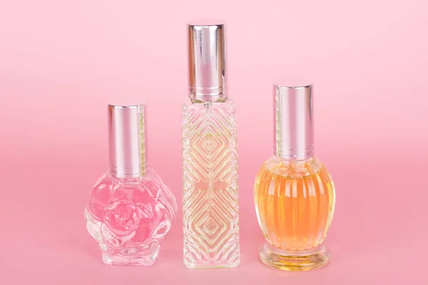 Different Transparent Perfume Bottles Pink Background Aromatic Essence Bottles Perfumery — Stock Photo, Image