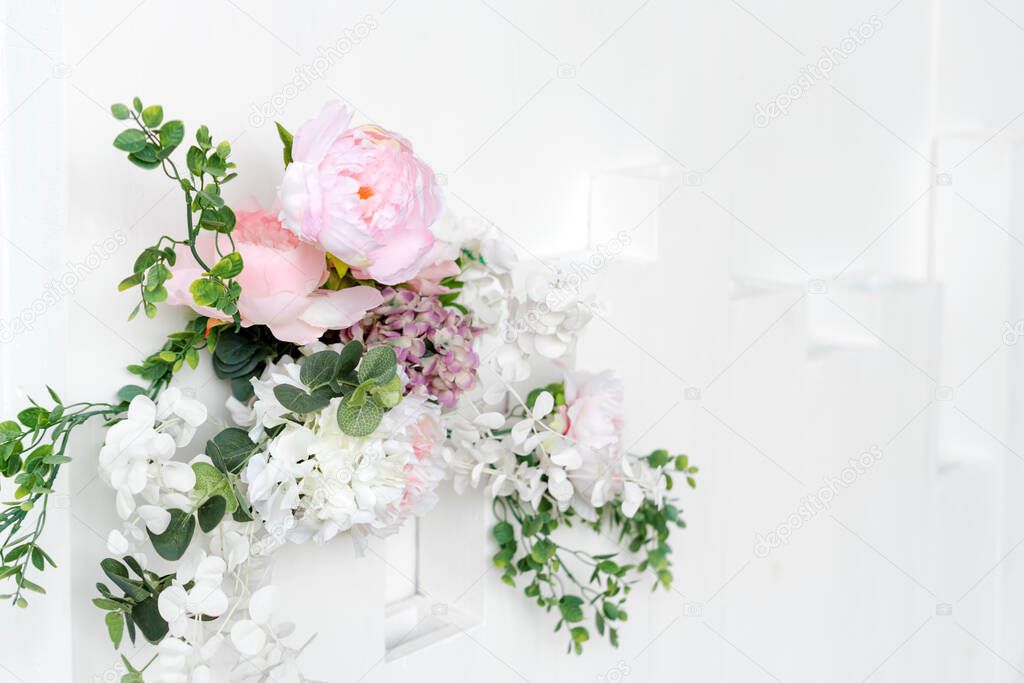 Flower wall, wedding backdrop, floral hand made decoration. Light background of artifical flowers. Vertical garden with peonies and hydrangeas. Elegant arrangement floristics setting. Copyspace