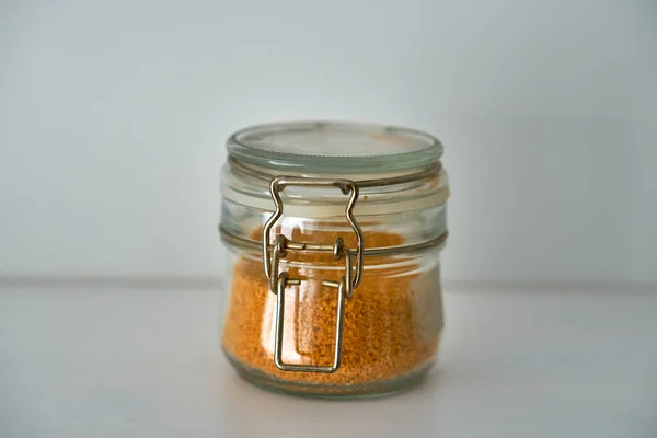 Glass jars with lid for food on a white shelf. Storage in kitchen. Containers