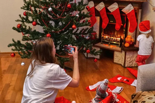Mom takes her daughter on phone at Christmas. New Years shooting on mobile.