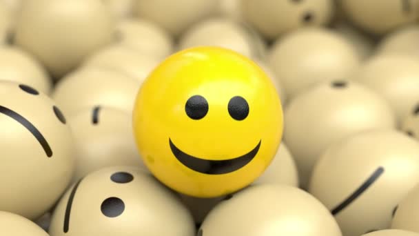 Šťastný optimistický míč přikyvující a usmívající se na hromadě smutných koulí. — Stock video