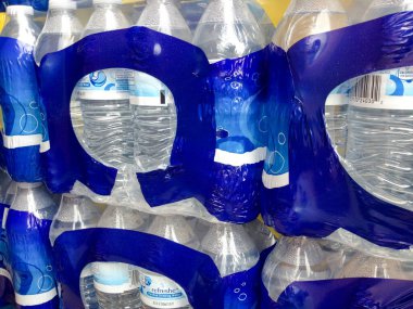 Süpermarkette kapaklı plastik su şişeleri.