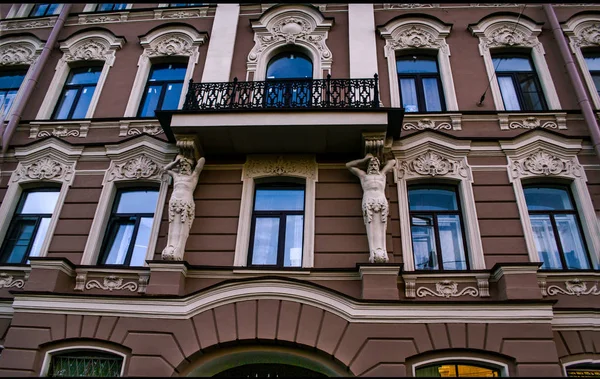 house with blue Windows and rounded arches, white arches on the windows