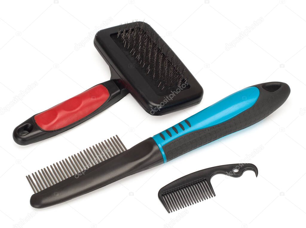 Close-up of a special veterinary tools for dog combing that lie on white background