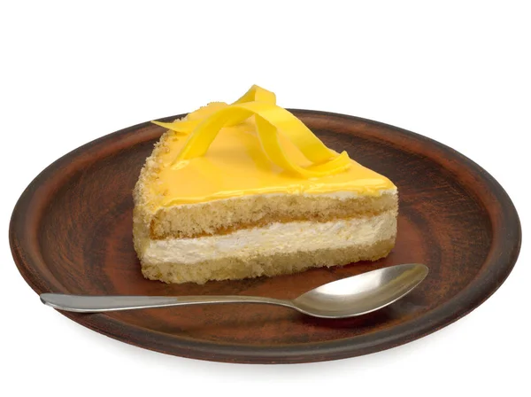 A piece of biscuit cake with cream and lemon cream on a plate. — Stock Photo, Image