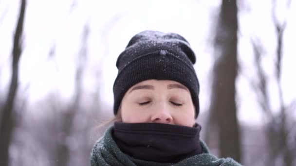 Крупный план женского лица среди снежных деревьев в зимнем лесу — стоковое видео