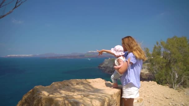 Güzel anne iskelede duran ve elinde onu küçük bebek kız kızı tutarak ve yaz aylarında çok nazikçe ona sarılma, Yavaş hareket — Stok video