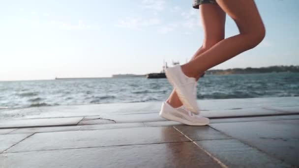 Junior girl walking and running near sea — Stock Video