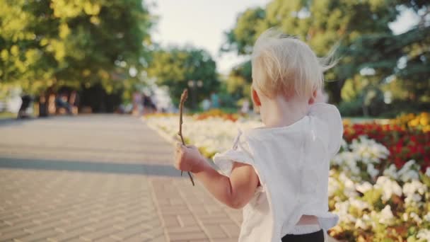 Malá dětská holčička v příležitostných prostorách tráví den venku — Stock video