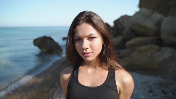 Young adult woman looking at camera with calm face — Stock Video