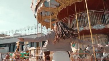 Genç bir kadın lunaparkta dönüp duruyor.