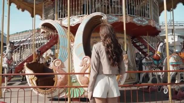 Young adult model spending day near carousel in city — Stock Video