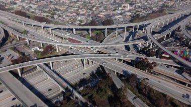 Cinematic 4K aerial drone footage capturing a descending shot over the Judge Harry Pregerson Interchange in Los Angeles, California, filmed in February 2025. The camera smoothly moves downward