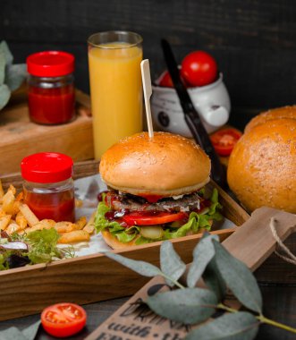 Hamburger ketçap ve patates kızartması ile servis