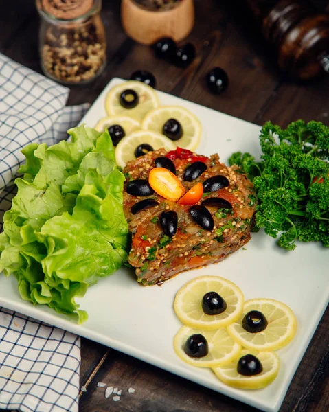 Eggplant caviar and lemon topped with olives