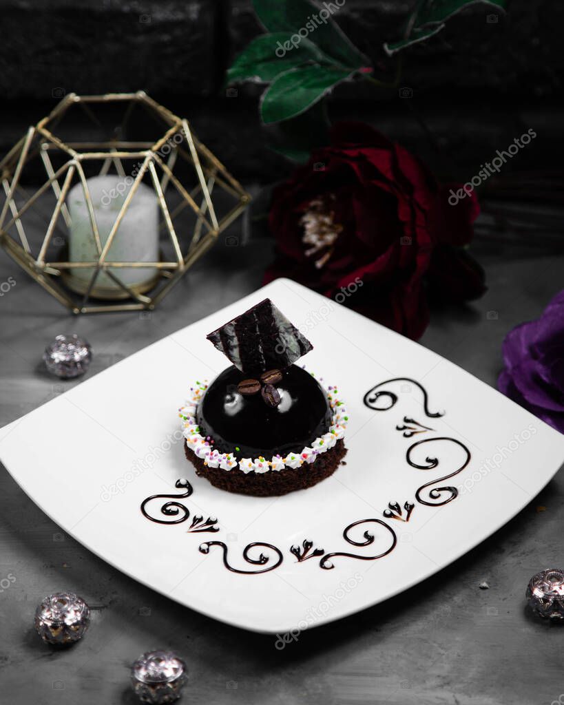 small black cake decorated with chockolate