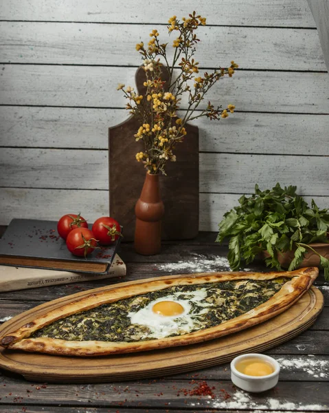Spinach pide with egg on wood serving board  — 無料ストックフォト