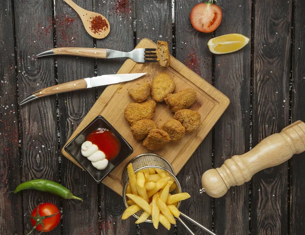 Top view of chicken nuggets served with ketchup, mayonnaise and french fries — Stok fotoğraf