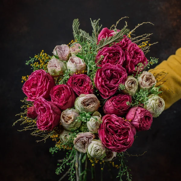 roses bouquet with purple roses with dense petals, cream pink roses, mimosa