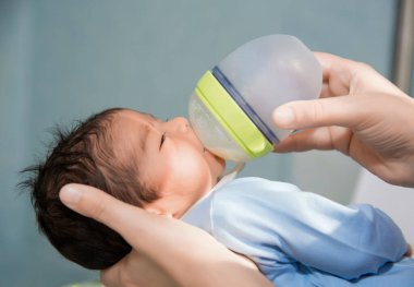 Yeni doğan bebek hastanede küçük bir şişeyle besleniyor.