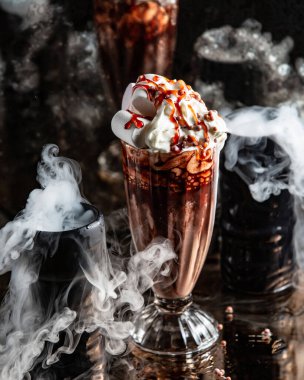 chocolate milkshake topped with whipped cream, marshmellow and caramel syrup clipart