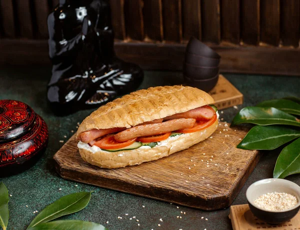 Hotdog bread stuffed with sausages, tomatoes, cucumber and mayonnaise  — 無料ストックフォト