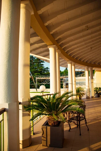 outdoor summer terrace, with stylish furniture, in a cafe at sunset