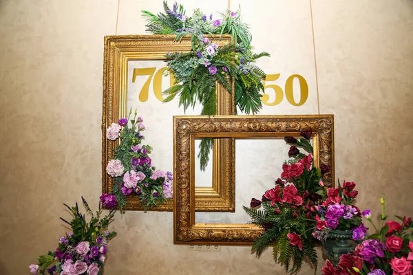 decor of the photo zone with the numbers fifty and seventy, a place for a photo shoot, for an anniversary