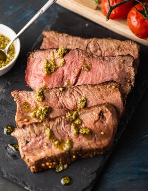 Üzerinde kesme tahtası ızgara sebzeli biftek dilimlenmiş 