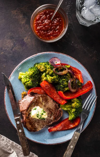 Sarımsak tereyağı ve sebze ızgara sığır eti biftek. Et ızgara dolmalık biber, brokoli ve soğan ile.