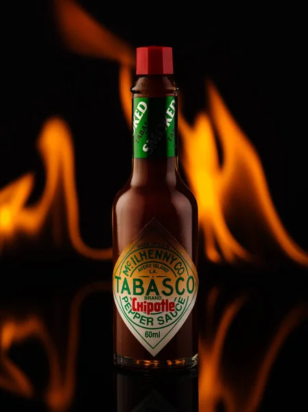 Belarus, Minsk - November 22, 2018: Tabasco sauce bottles with chipotle sauce on fire background