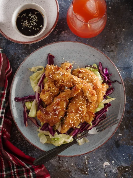 Salad with warm glazing chicken, sprinkled with sesame seeds. Chinese cuisine. Asian culture.