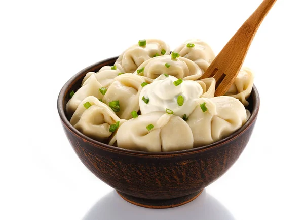 Homemade meat dumplings - russian pelmeni. Dumplings, filled with meat on white background. Isolated on white.