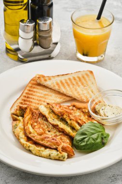 Otlar, ekmek ve tereyağı ile Omlet. Portakal suyu ile sağlıklı kahvaltı.