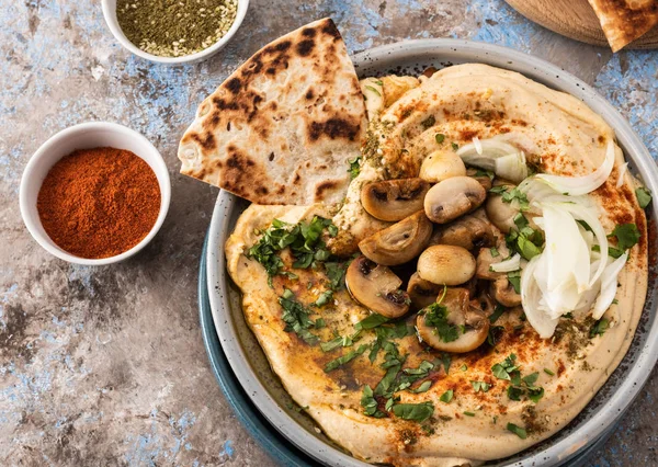 Mantar ve soğan ile geleneksel Akdeniz humus. Kırmızı biber, zeytinyağı, soğan, mantar ve baharatile Klasik Humus.