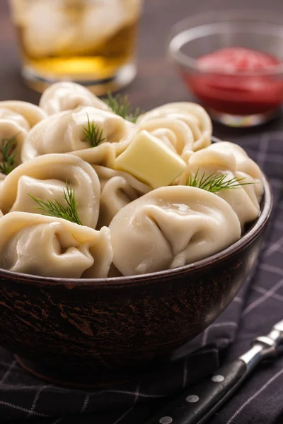 Homemade meat dumplings - russian pelmeni. Dumplings, filled with meat, ravioli. Dumplings with filling.